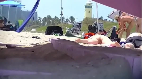 Exhibitionist Wife 63 - Tatiana teasing NUDE BEACH VOYEUR cocks while her hubby takes a nap!